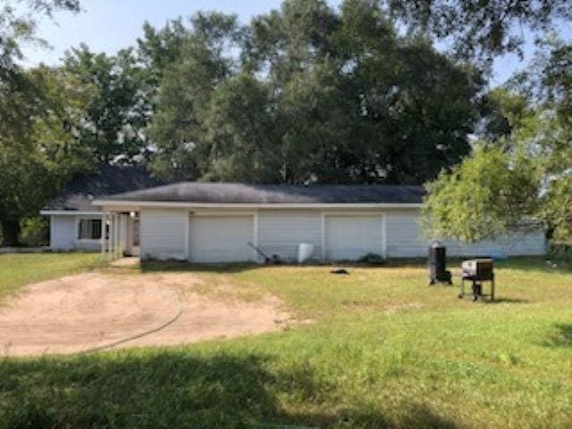 exterior space featuring a lawn and a garage