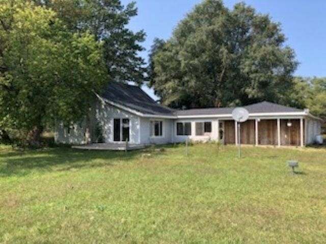 back of house featuring a yard