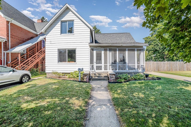 view of front of house featuring a front yard and a sunroom