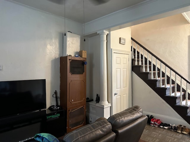 living room with ornamental molding and ornate columns