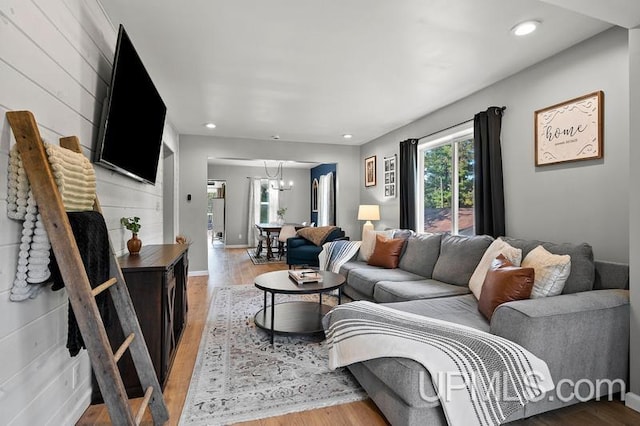 living room featuring hardwood / wood-style flooring and an inviting chandelier