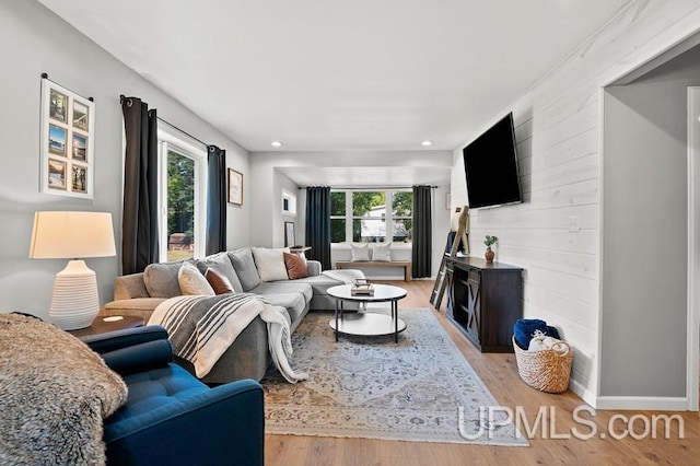 living room featuring a wealth of natural light and light hardwood / wood-style floors