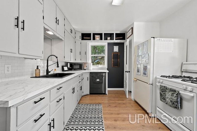 kitchen featuring gas range gas stove, light hardwood / wood-style floors, white cabinetry, sink, and stainless steel dishwasher