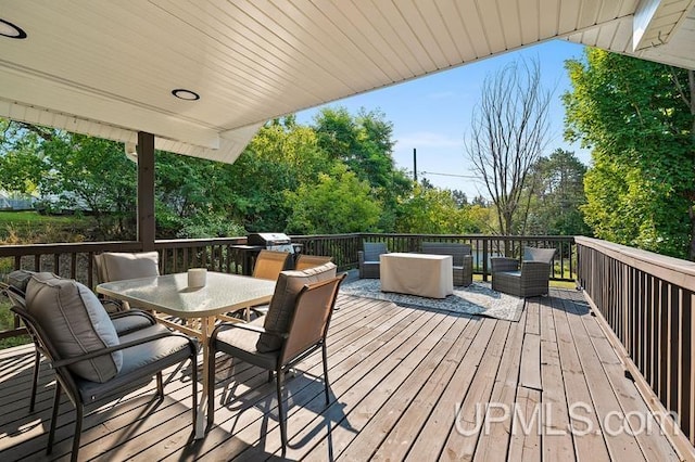 wooden terrace with an outdoor living space