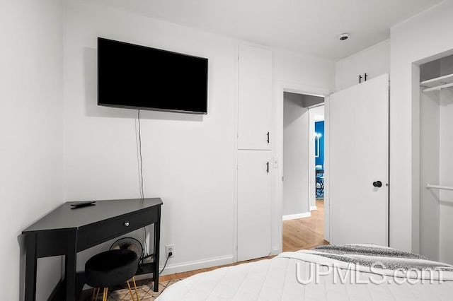 bedroom with a closet and wood-type flooring