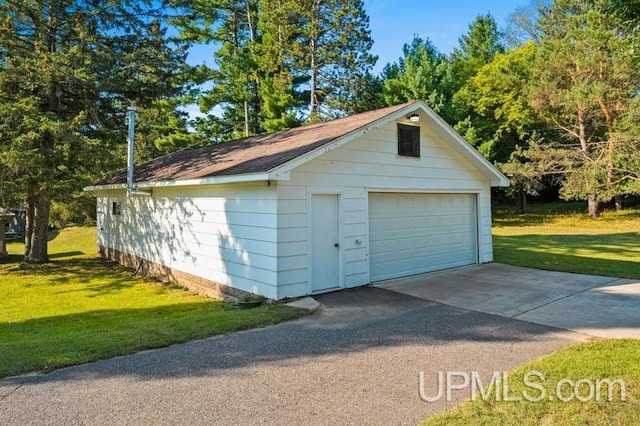 garage featuring a yard