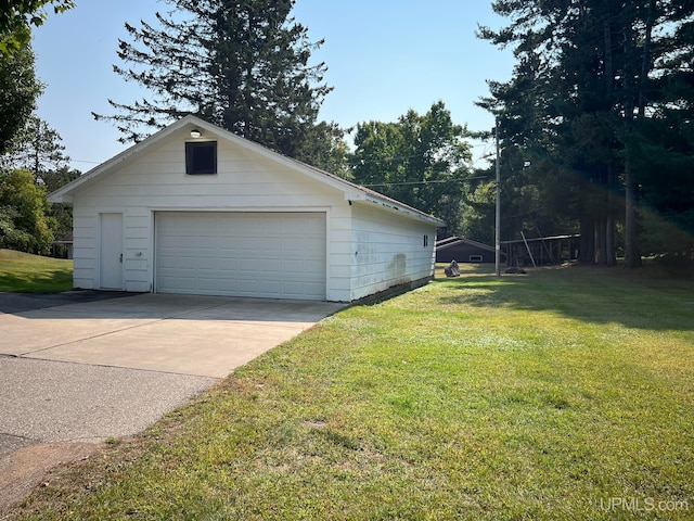 exterior space with a garage and a yard