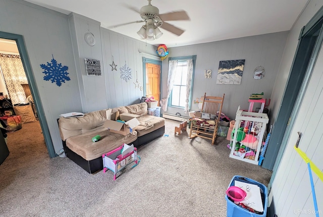 living room with a baseboard radiator, ceiling fan, and carpet