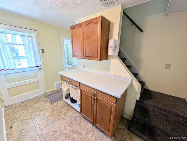 510-512 W Bluff St, Marquette, MI 49855 - kitchen with brown cabinetry, light countertops, and a textured ceiling