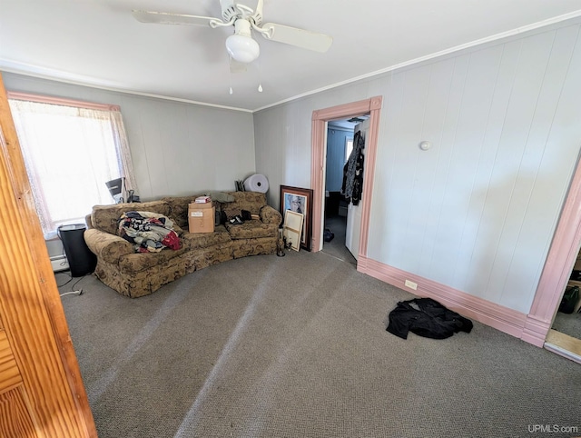 living room featuring ceiling fan, ornamental molding, and carpet floors