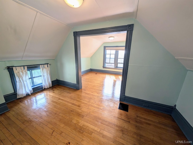 510-512 W Bluff St, Marquette, MI 49855 - additional living space with vaulted ceiling, hardwood / wood-style flooring, and baseboards