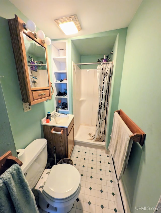 bathroom featuring a shower with shower curtain, toilet, and vanity