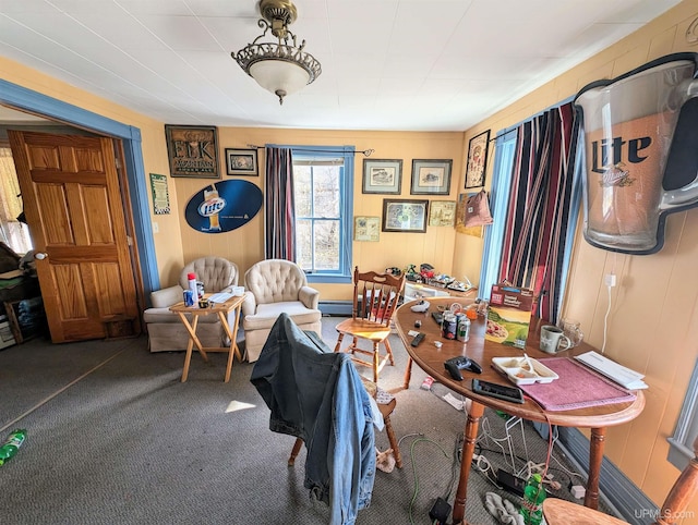 interior space with a baseboard heating unit and carpet