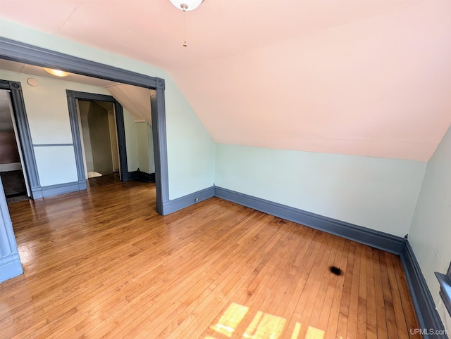 bonus room with lofted ceiling and hardwood / wood-style flooring