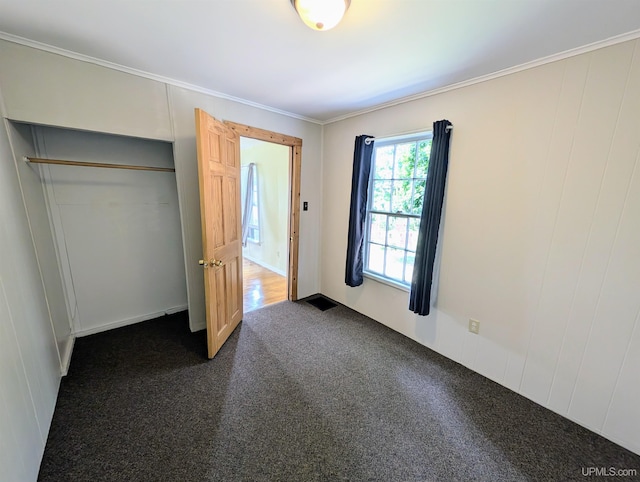 510-512 W Bluff St, Marquette, MI 49855 - unfurnished bedroom featuring dark carpet and crown molding
