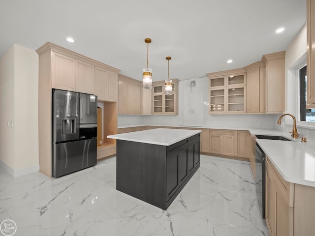 kitchen with sink, stainless steel fridge with ice dispenser, pendant lighting, light brown cabinetry, and a kitchen island