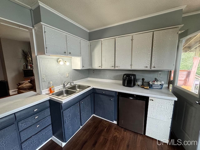 kitchen featuring dishwasher, crown molding, dark hardwood / wood-style flooring, and sink