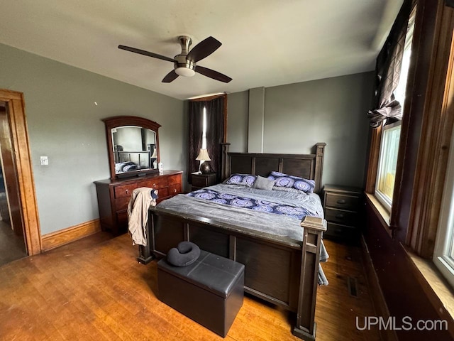 bedroom with hardwood / wood-style floors and ceiling fan