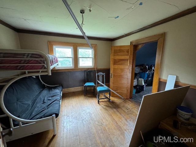 sitting room with crown molding and hardwood / wood-style floors