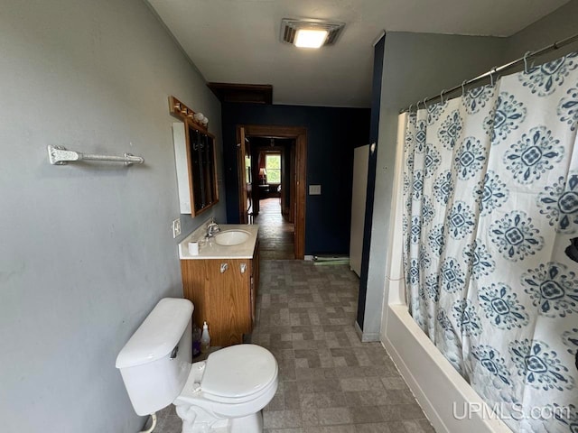 full bathroom featuring vanity, toilet, and shower / bath combination with curtain