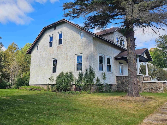 view of side of property with a yard