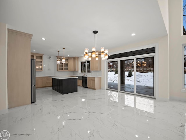 kitchen with stainless steel refrigerator, black dishwasher, a chandelier, decorative light fixtures, and a kitchen island