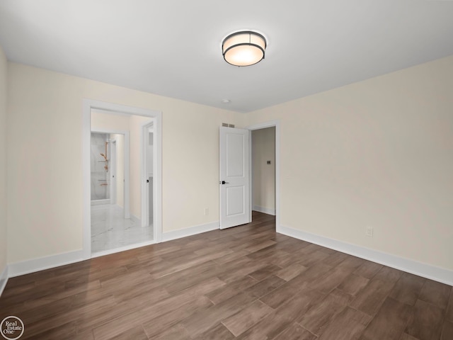 spare room featuring hardwood / wood-style floors