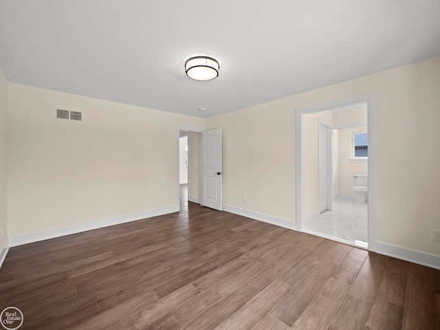 empty room with wood-type flooring