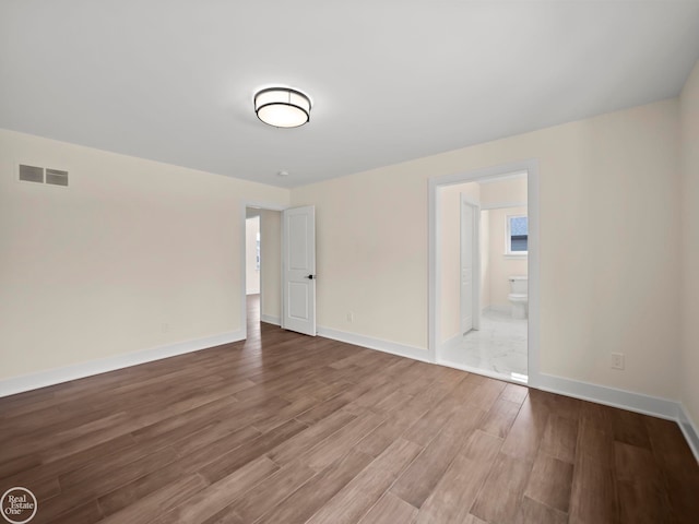 unfurnished room featuring hardwood / wood-style flooring