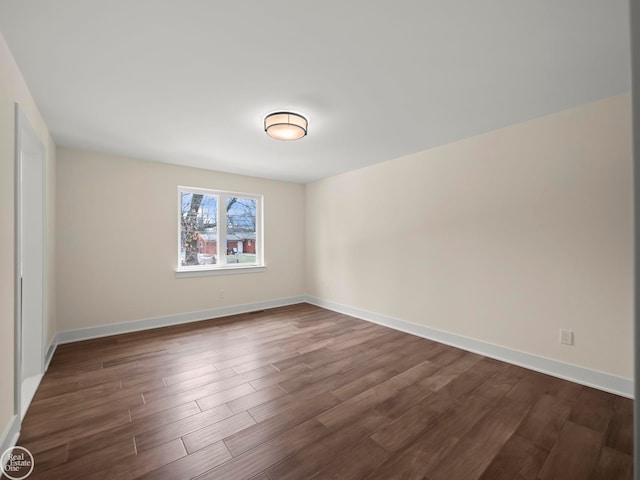 unfurnished room with dark hardwood / wood-style floors