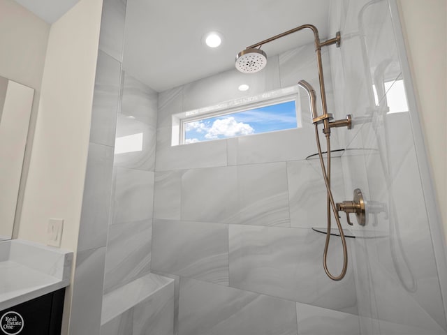 bathroom with tiled shower