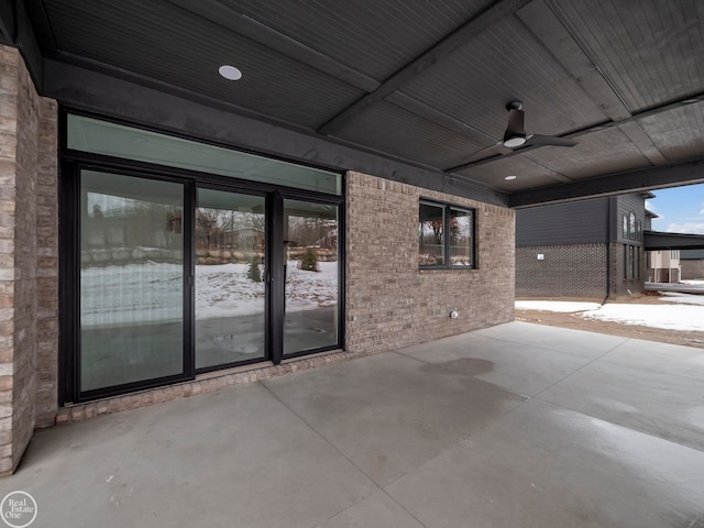 snow covered patio with ceiling fan