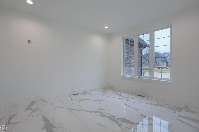 unfurnished room featuring visible vents, recessed lighting, marble finish floor, and baseboards