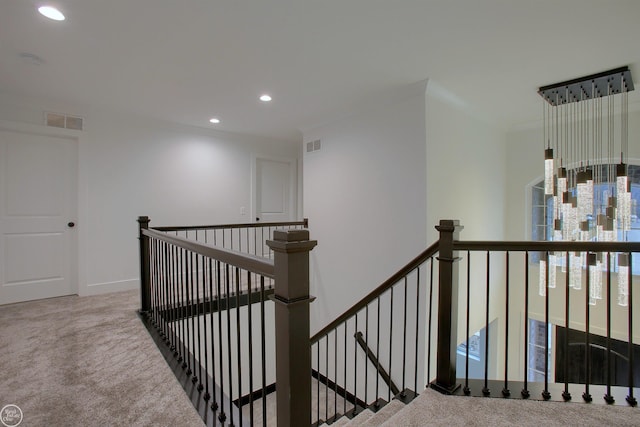 corridor featuring recessed lighting, visible vents, an upstairs landing, and carpet flooring