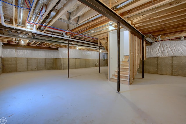 unfinished basement featuring stairway