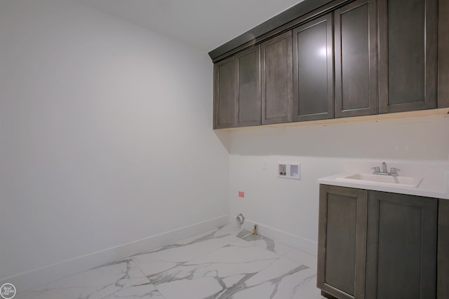 laundry area with hookup for a washing machine, sink, cabinets, and hookup for a gas dryer