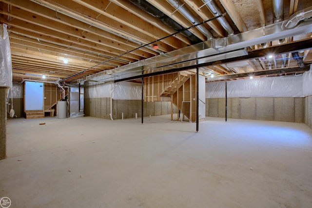 basement with water heater and heating unit