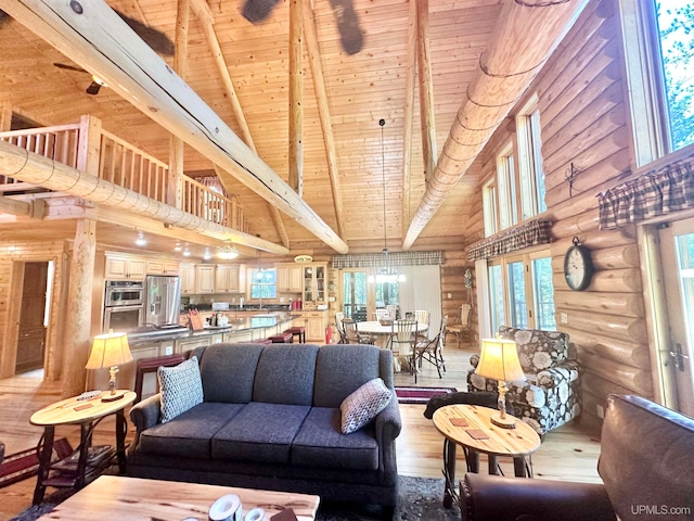 living room with wooden ceiling, beamed ceiling, a notable chandelier, wood-type flooring, and high vaulted ceiling