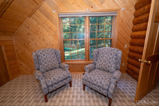 sitting room with vaulted ceiling, wood walls, and wooden ceiling