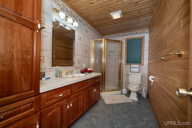 bathroom with a shower with shower door, vanity, wooden ceiling, tile walls, and toilet