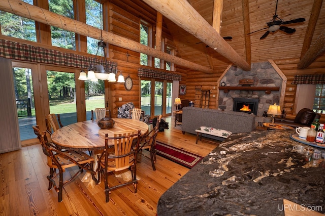 N5491 Foster City Rd, Vulcan, MI 49892 - dining space featuring rustic walls, light wood-type flooring, high vaulted ceiling, and plenty of natural light