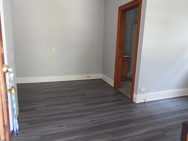 unfurnished room with dark hardwood / wood-style floors