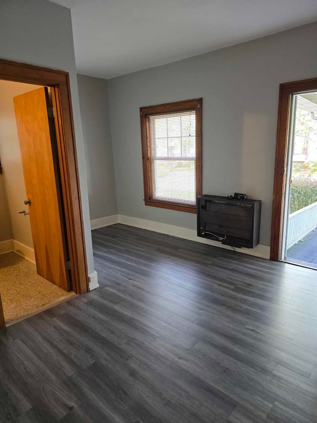 unfurnished living room with dark hardwood / wood-style floors and plenty of natural light