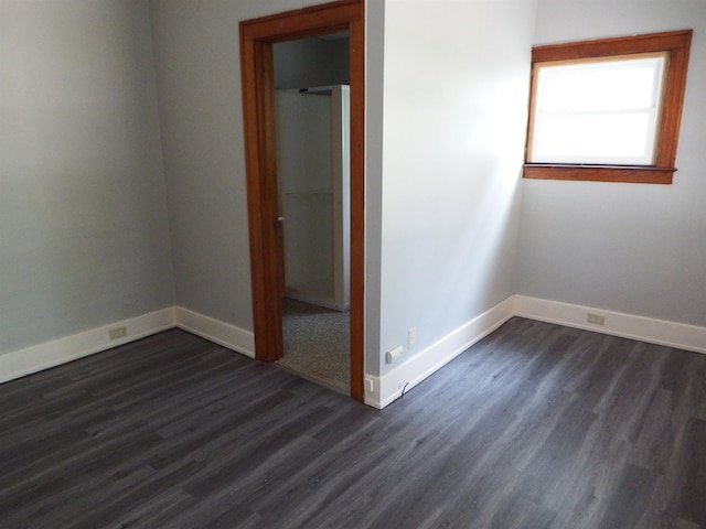 unfurnished bedroom featuring dark hardwood / wood-style flooring