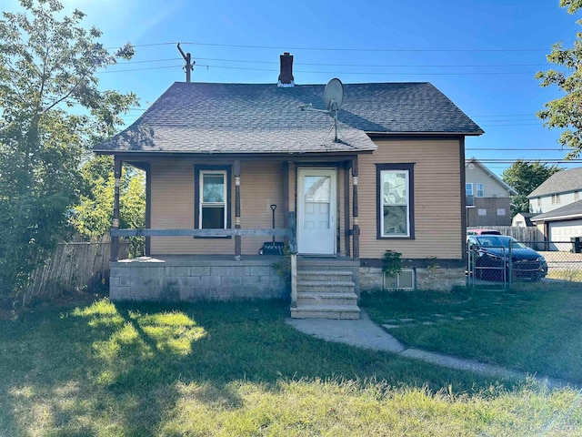 bungalow-style house with a garage and a front lawn