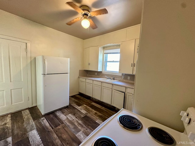 kitchen featuring dark hardwood / wood-style floors, white appliances, sink, ceiling fan, and white cabinets