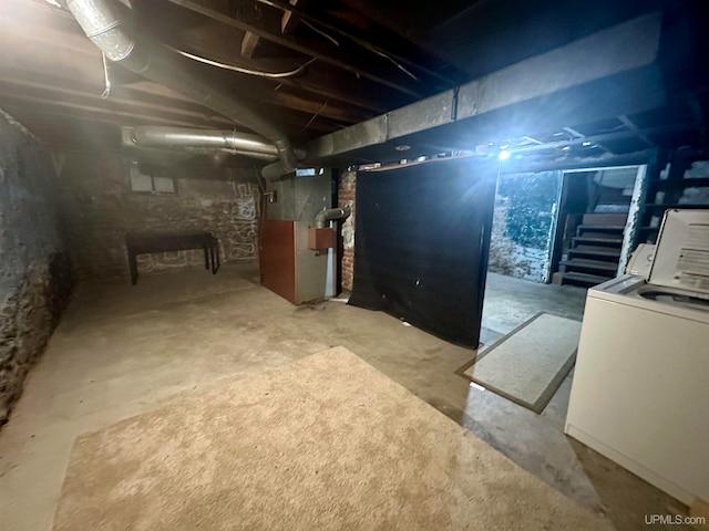 basement featuring washer / dryer and heating unit