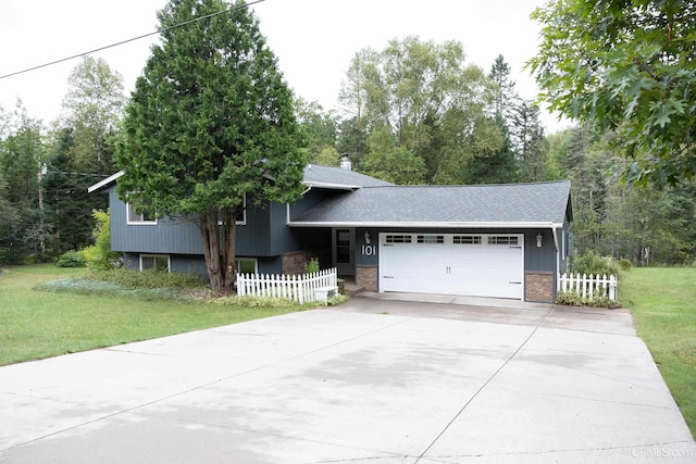 split level home featuring a garage and a front lawn