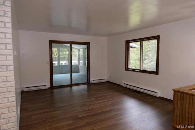 spare room featuring a wealth of natural light and baseboard heating