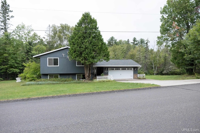 tri-level home with a garage and a front yard